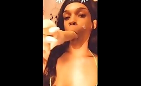 Sucking on a dildo, stroking, and busting a big nut