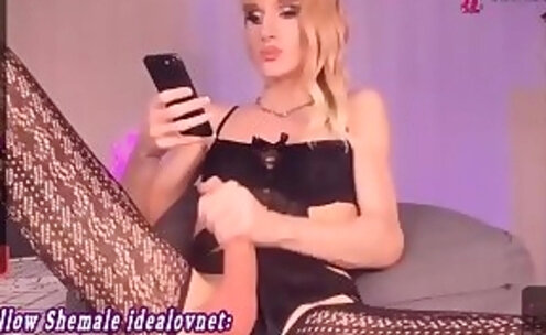 skinny Ukranian blonde translady in stockings tugs her big dick on cam