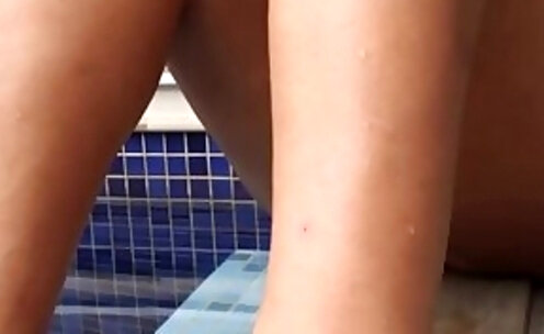 Beautiful shemale shows her cute little feet by the pool